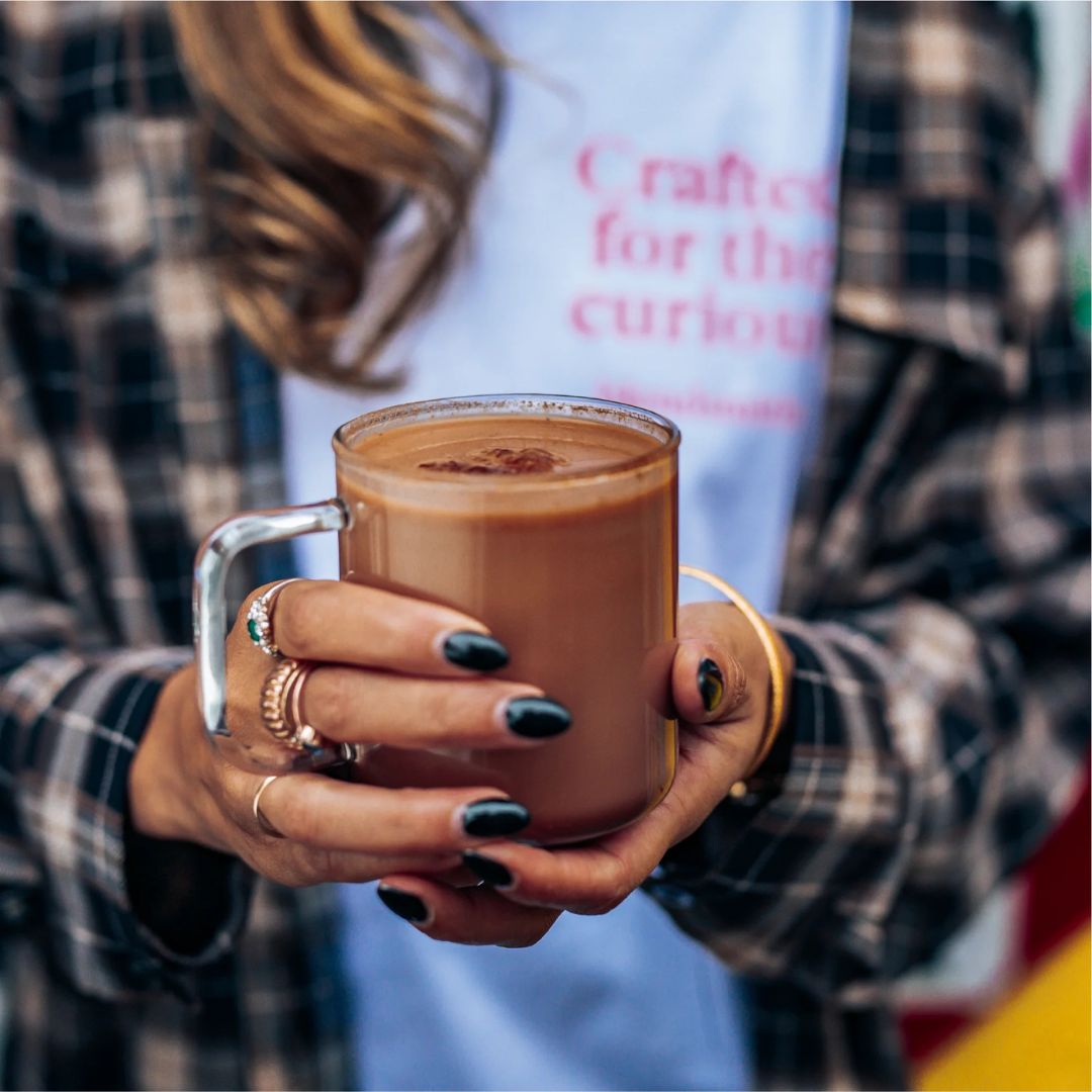 Image of a woman holding a cup of And Breathe...Ashwagandha Hot Chocolate