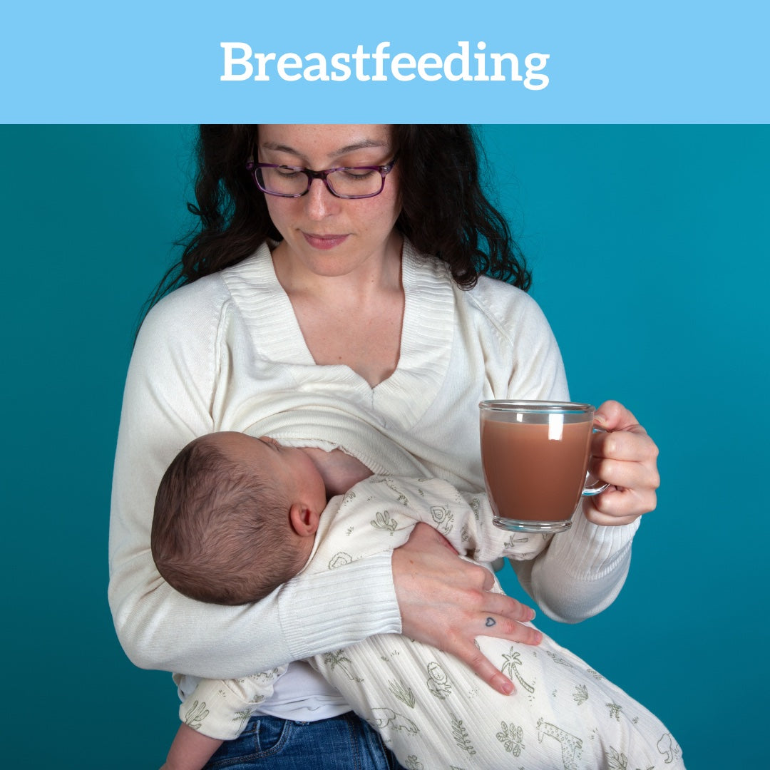 Lady breastfeeding her baby while holding a cup of lactation support hot chocolate on turquoise background, with breastfeeding title written on blue banner