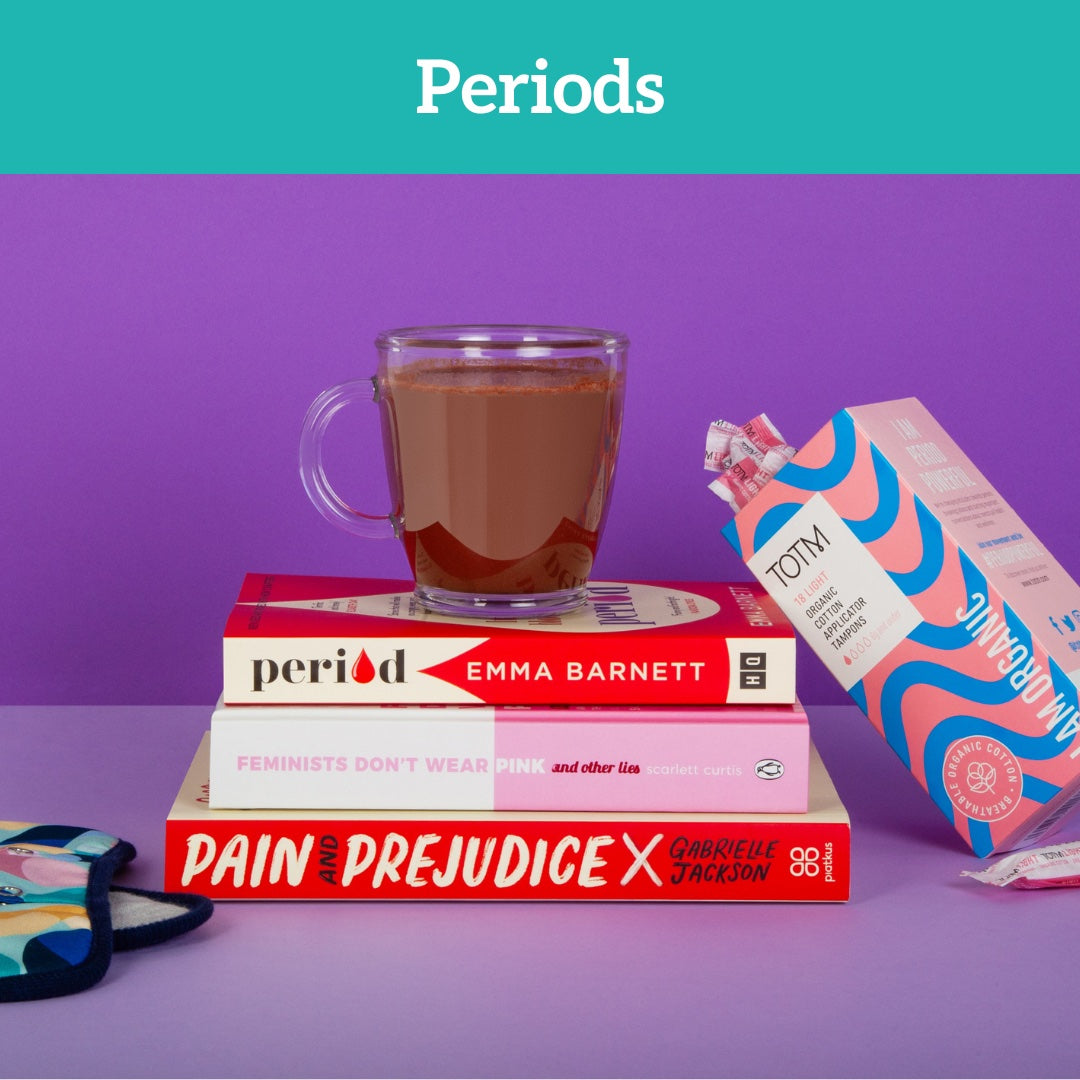 Cup of HotTea Mama hot chocolate sat on top of period and endometriosis books, with organic tampons and period pads